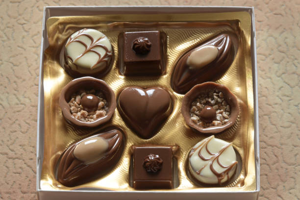 9 sweet chocolate candies in a square gift box. Chocolate candies.