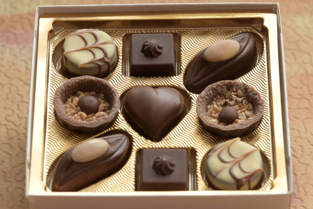 9 sweet chocolate candies in a square gift box.