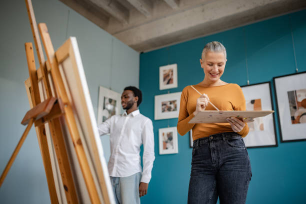 istock Creative interaction in an art studio with vibrant atmosphere and engaged artists working on their projects 2195106136