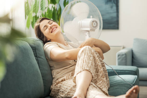 istock Woman blowing fresh air on her face 2195106724