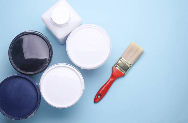 istock Clean paintbrush with paint cans on blue background. Top view 2195107428