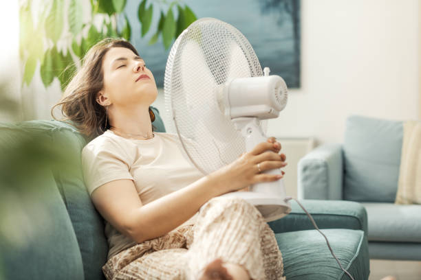 istock Woman blowing fresh air on her face 2195107449