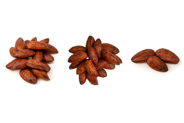 A group of caramelized almonds isolated on a white background.