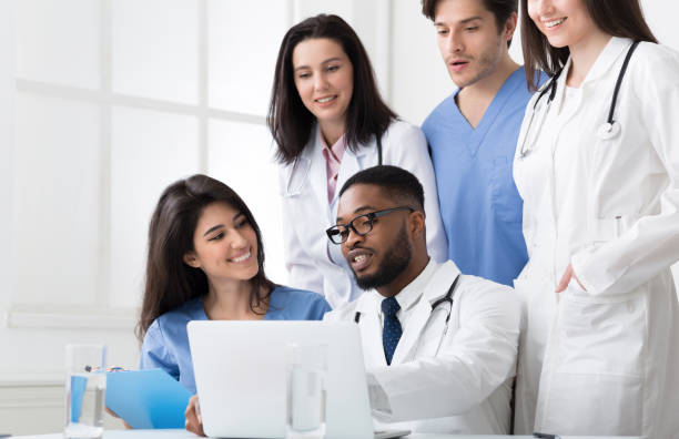 istock Team of interns and practitioners examining medical reports 2195107663