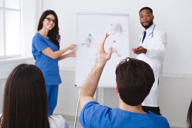 istock Medical Education. Doctors Giving Lecture To Interns At Seminar 2195107749