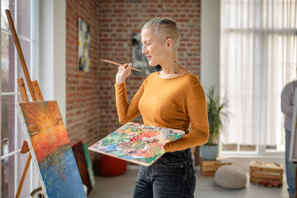 istock Creative artist working on a vibrant painting in a bright art studio during daylight hours 2195107868