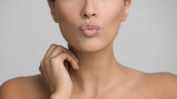 istock Woman Sending Air Kiss, Pouting Lips Over Grey Background 2195111837