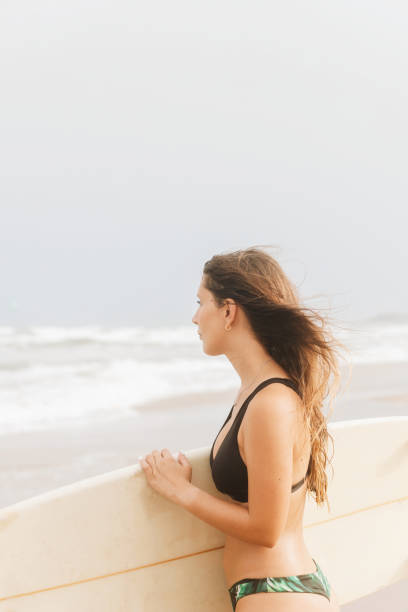 istock Surfer with surfboard on head on sea beach 2195112577