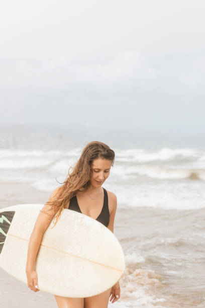 istock Surfer with surfboard on head on sea beach 2195112578