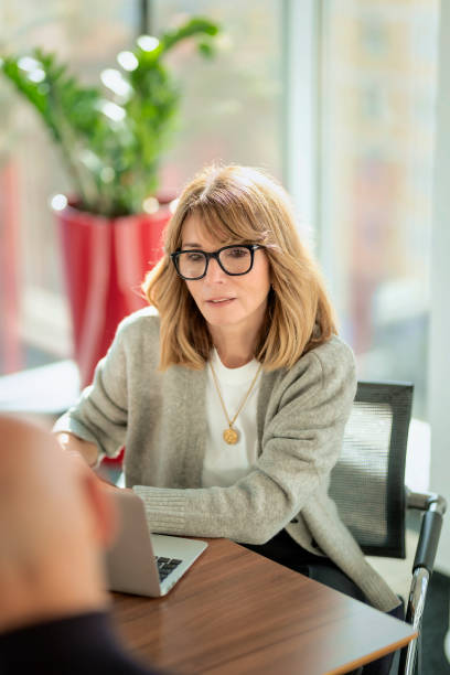 istock Business people sitting at desk and working in a bright office 2195115962