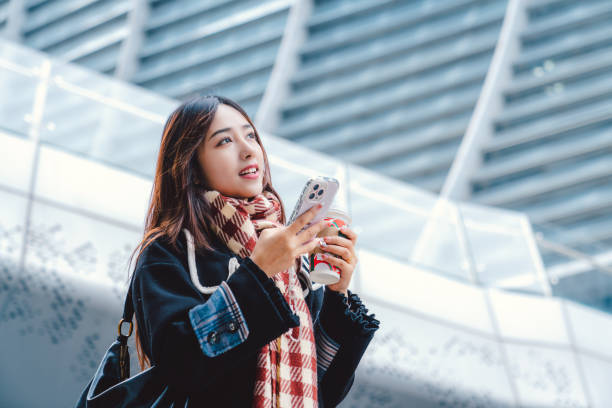 Young asian girl using smartphone in the city.