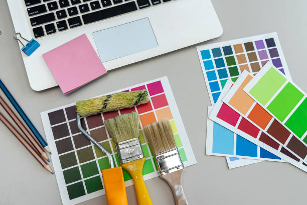 istock Paper color catalog for tinting facade and interior paints with brushes on desk 2195116087
