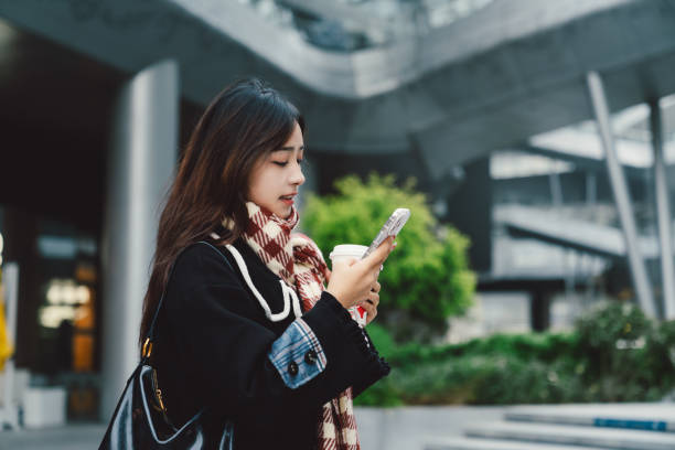 istock Young asian girl using smartphone in the city. 2195116097