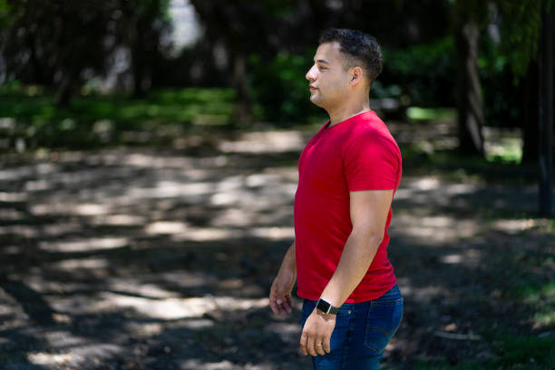istock Attractive young man in profile in a park 2195117755