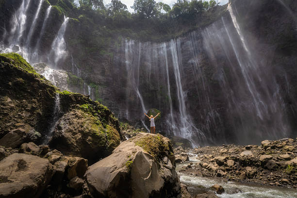 istock A Stunning Waterfall Cascading Gracefully Down Majestic Rocky Cliffs, All Surrounded by Vibrant Lush Greenery 2195117887
