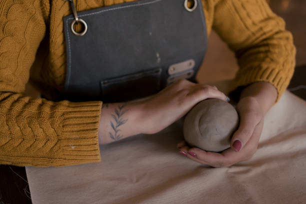 istock Unrecognizable woman molding clay by hands 2195118534