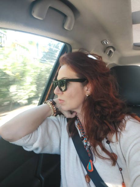 istock Sad woman looking out car window 2195121445