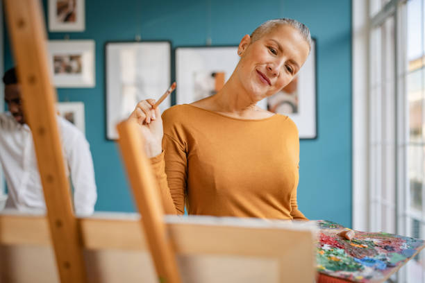 istock Artist creates vibrant artwork in a bright, inviting art studio with a modern aesthetic 2195123595