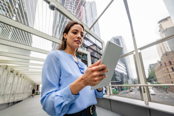 istock Businesswoman in Sydney utilize technology for work while navigating the modern city landscape 2195126042