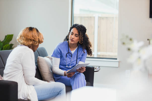 istock Doctor and Patient in a Home Consultation using Tablet 2195126237