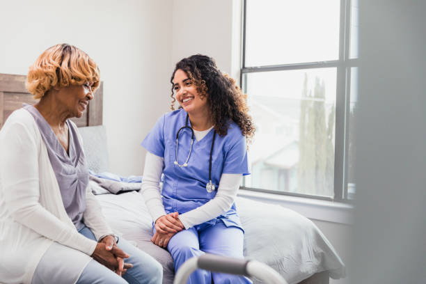 istock Home Healthcare: Nurse and Senior Patient Enjoying a Cheerful Conversation 2195126284