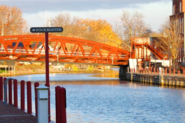 istock Dockmaster Sign Along Waterway With Bridge And Fall Colors In The Background 2195129285