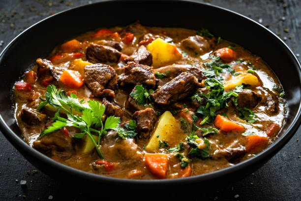istock Beef stew with vegetables and potatoes on black table 2195130257