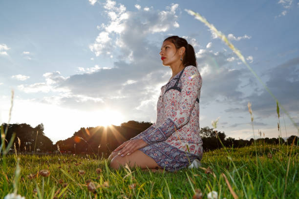 istock Woman meditating in natural park 2195130347