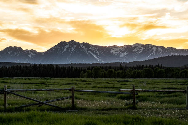 istock Serene Sunset Over Mountain Range With Wooden Fence in Foreground 2195130376