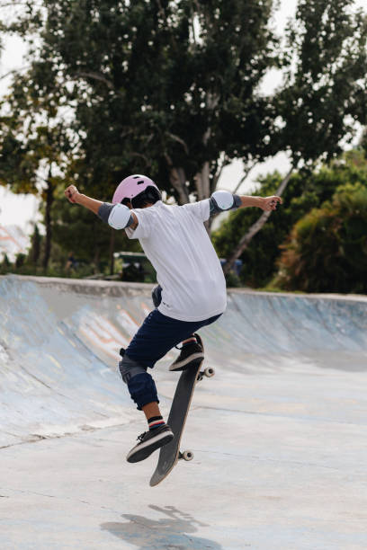 istock Young person with skateboard in skate park 2195130566
