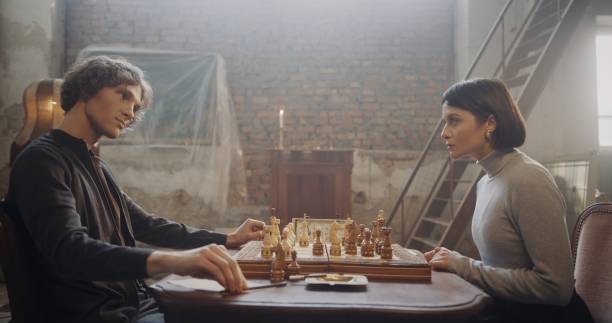 istock Man and Woman Playing Chess in a Rustic Loft Setting with Vintage Decor 2195134788