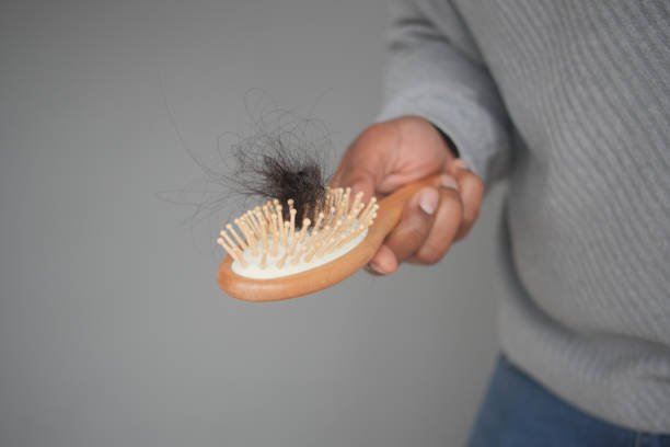 istock man hold his list hair close up 2195134891