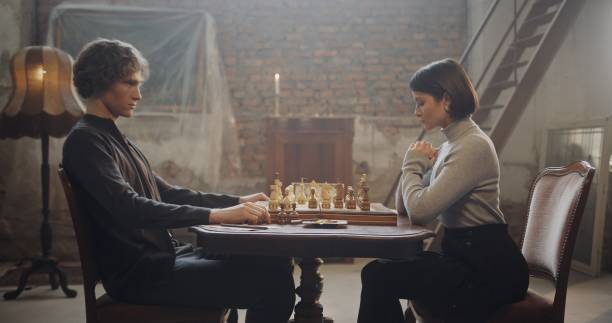 istock Intense Chess Game Between Man and Woman in a Vintage Loft Setting 2195135356