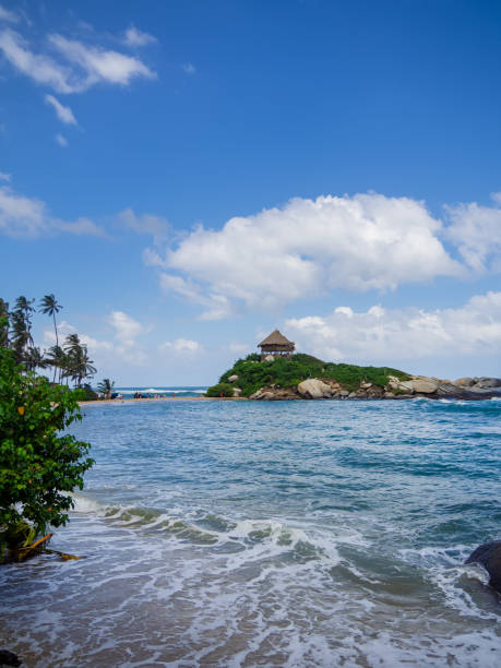 istock Scenic Tropical Beach with Island Hut and Palm Trees. 2195135474