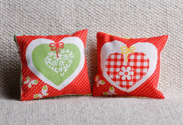 Two red cushions with polka dots,hearts and butterflies