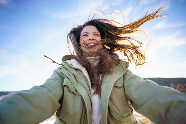 istock A woman with brown hair is having fun while spinning outside 2195136485