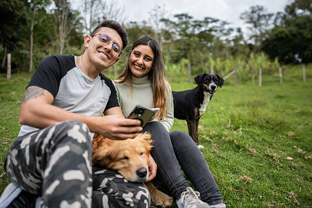 istock Portrait of a couple using mobile phone on a farm 2195139103