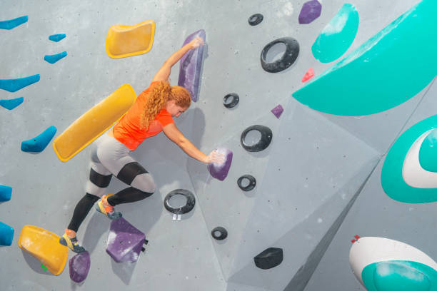 istock Determined woman climbing on an indoor bouldering wall 2195139809