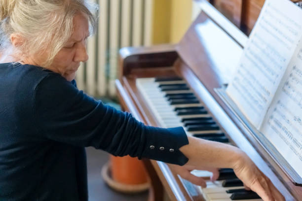 istock Female pianist  playing  piano at home 2195141632