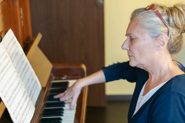 istock Female pianist  playing  piano at home 2195141660
