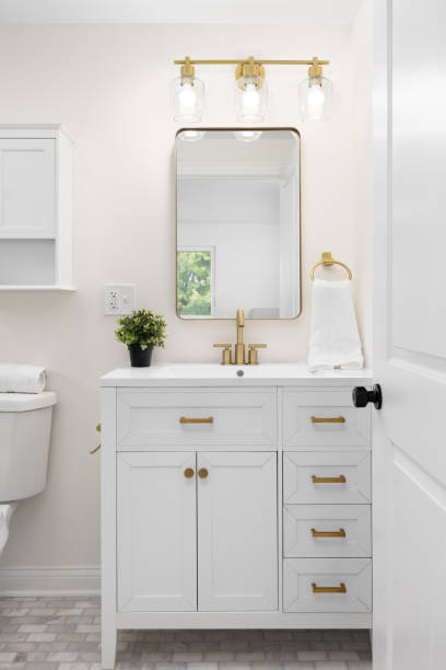 istock A white bathroom with gold accents and a subway tile floor. 2195145141