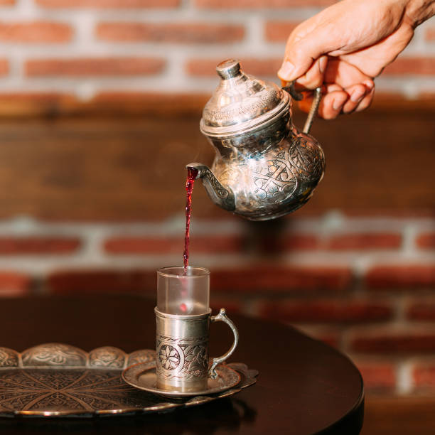 istock Vintage Turkish Silverware Pouring Red Tea on Traditional Serving Tray 2195145450