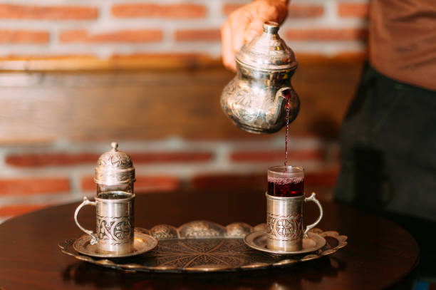 Dallah, metal pot for making Arabic coffee on ornamental table, Oman