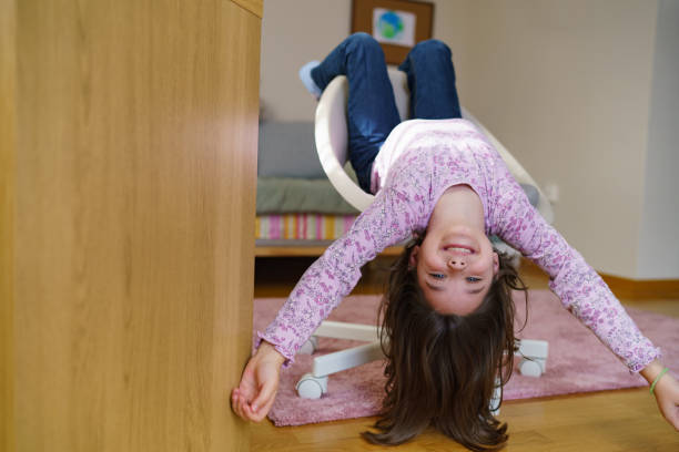 istock Girl lying upside down on the armchair 2195147517