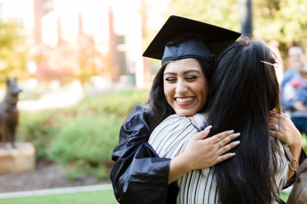 istock Happy Graduate Hugging Loved One Outdoors 2195149775