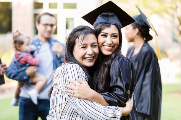 istock Happy Graduate Hugging Mother at Graduation 2195149777