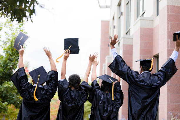 istock Excited Graduates Toss Caps at University 2195149803