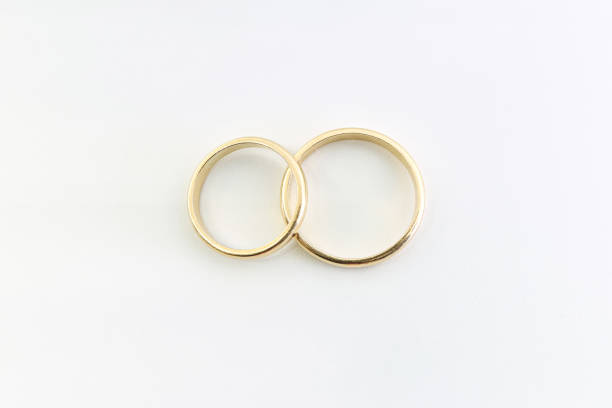 istock Two gold wedding rings. Marriage. White background. 2195151080