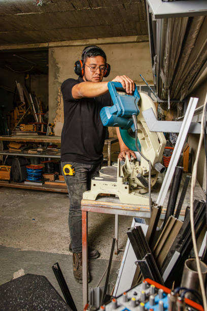 istock Industrial Worker Operating Metal Cutting Machine in Warehouse 2195152031