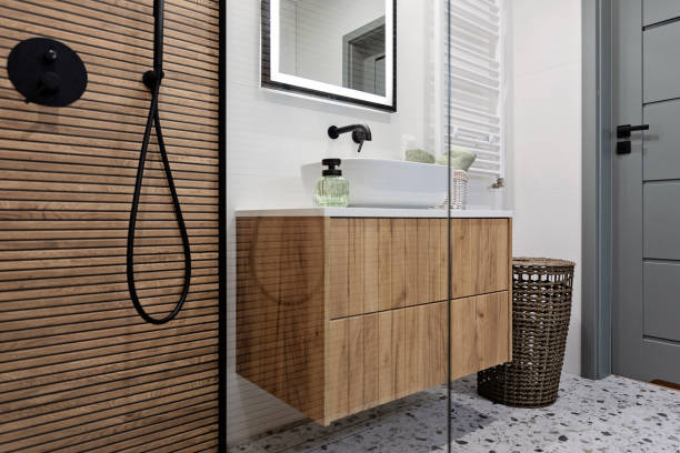 istock Interior decor. Ceramic bathroom sink with black water tap and brown striped tile on the wall and shower with glass. Real estate. 2195155182